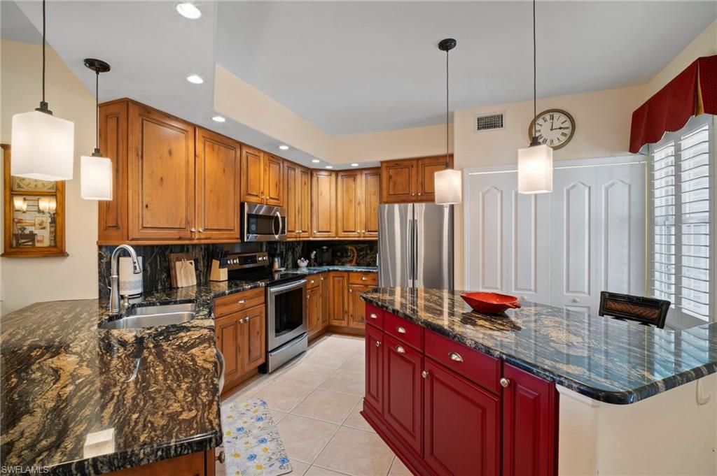 9281 Spring Run Boulevard, Unit 2607 Estero, FL 34135 - Photo 17 of 46 a kitchen with stainless steel appliances granite countertop sink stove and refrigerator