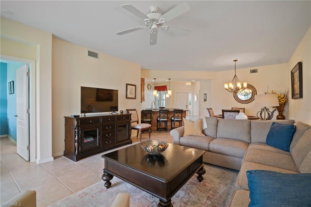 9281 Spring Run Boulevard, Unit 2607 Estero, FL 34135 - Photo 24 of 46 a living room with furniture a rug and a flat screen tv