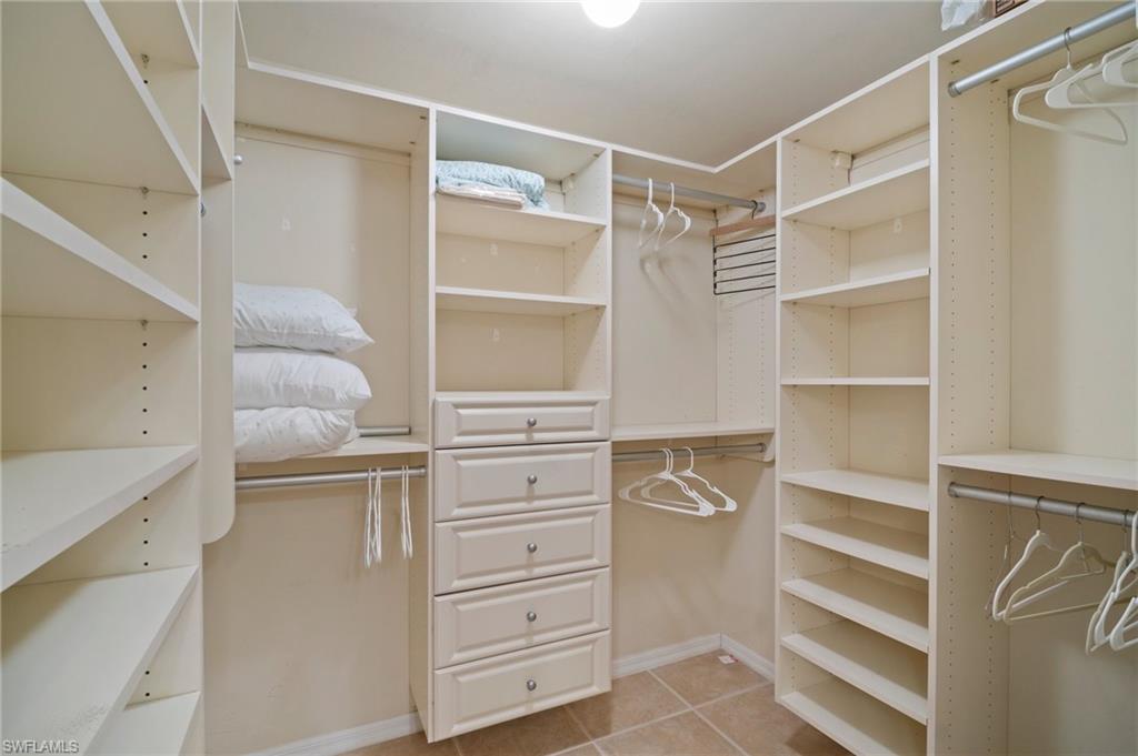 9281 Spring Run Boulevard, Unit 2607 Estero, FL 34135 - Photo 31 of 46 a walk in closet with white cabinets