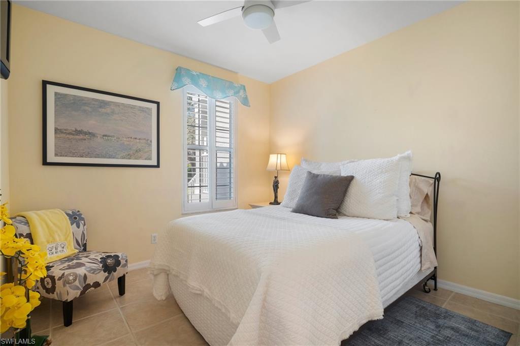 9281 Spring Run Boulevard, Unit 2607 Estero, FL 34135 - Photo 35 of 46 a bedroom with a bed and a couch