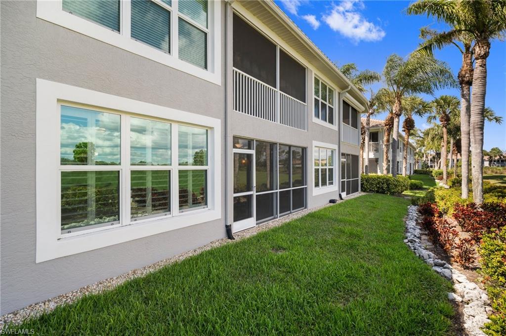 9281 Spring Run Boulevard, Unit 2607 Estero, FL 34135 - Photo 5 of 46 a view of building with green space