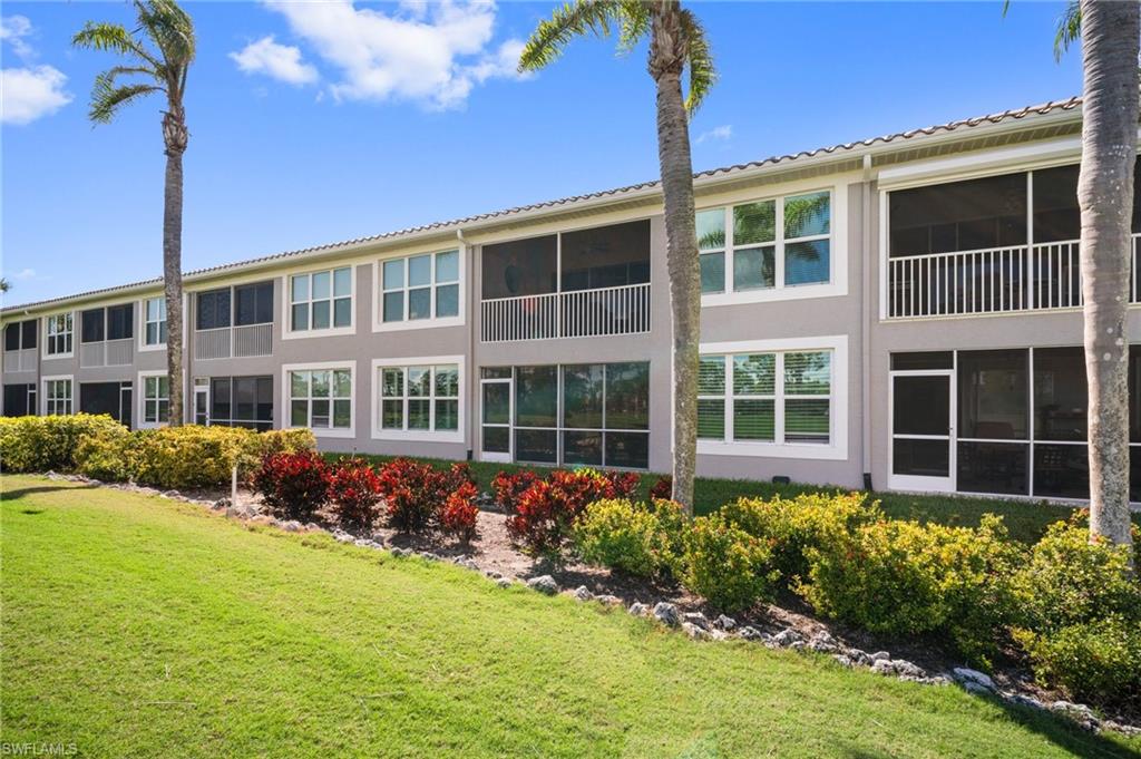 9281 Spring Run Boulevard, Unit 2607 Estero, FL 34135 - Photo 6 of 46 a front view of a house with a yard
