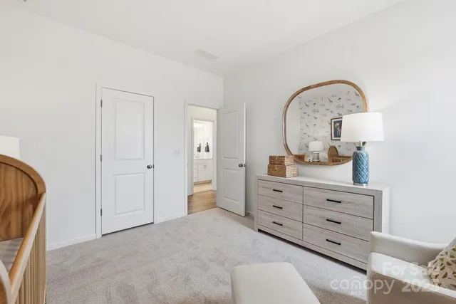 a bedroom with furniture and a lamp