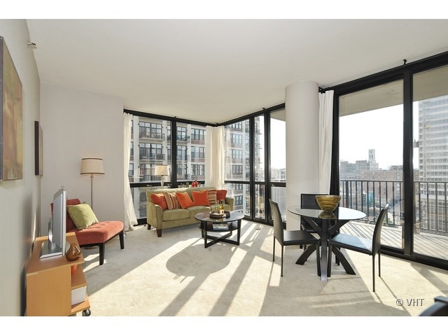 210 South Desplaines Street, Unit 910 Chicago, IL 60661 - Photo 2 of 12 a living room with furniture and a large window
