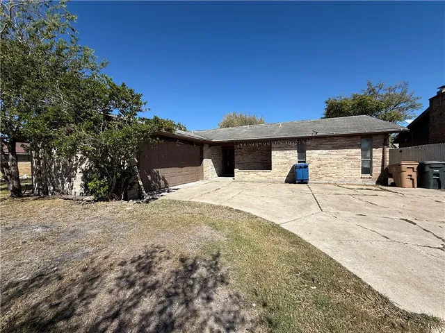 a view of a white house with a yard