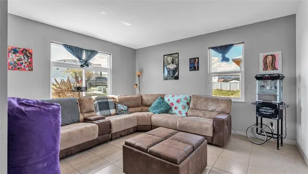 a living room with furniture and painting on the wall