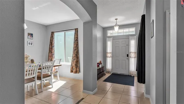 a view of a hallway with a livingroom and a dinning area