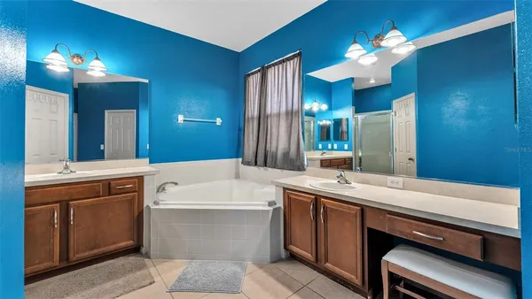 a bathroom with a sink a large mirror and a shower