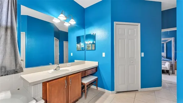 a bathroom with a sink a light fixture and a mirror