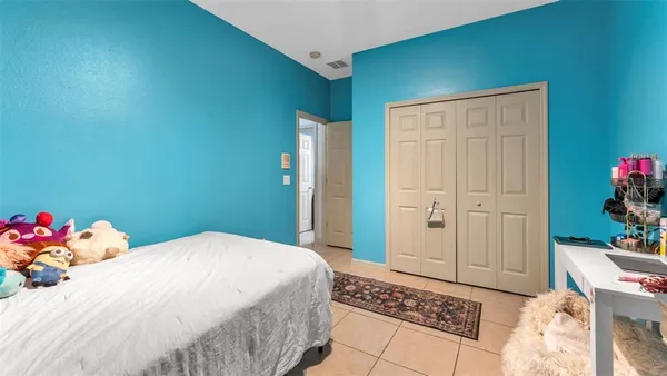 a bedroom with a bed and cabinets