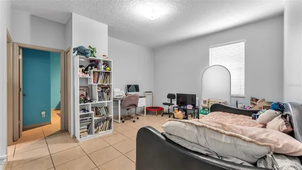 a living room with furniture and a shelf