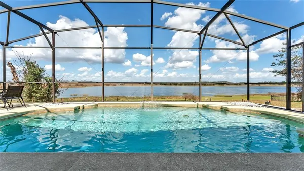 a view of a swimming pool with a yard