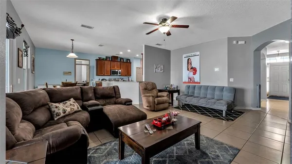 a living room with furniture a rug and a chandelier