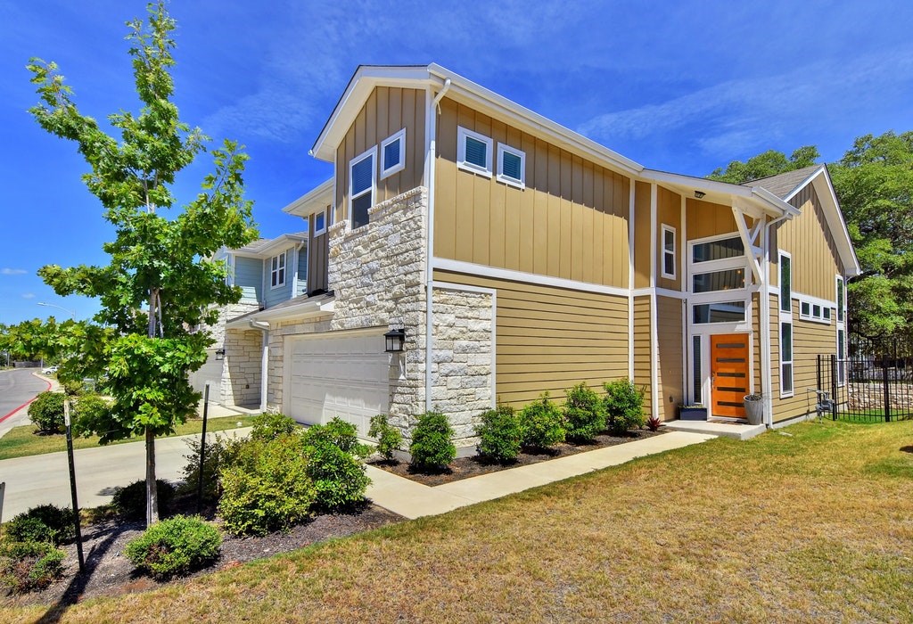 a front view of a house with plants