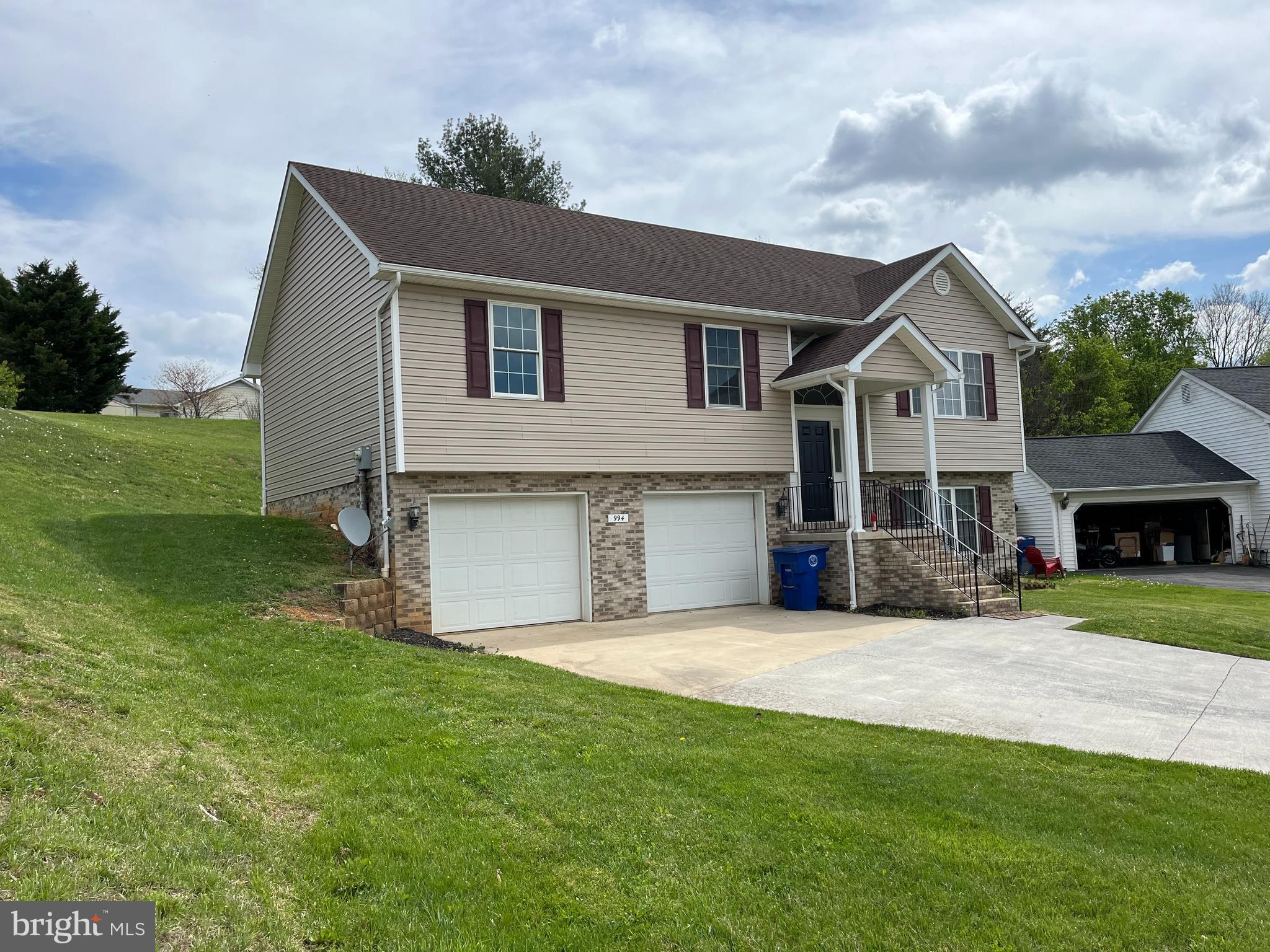 994 View Crest Court Front Royal, VA 22630 - Photo 4 of 24 a front view of a house with a garden and yard