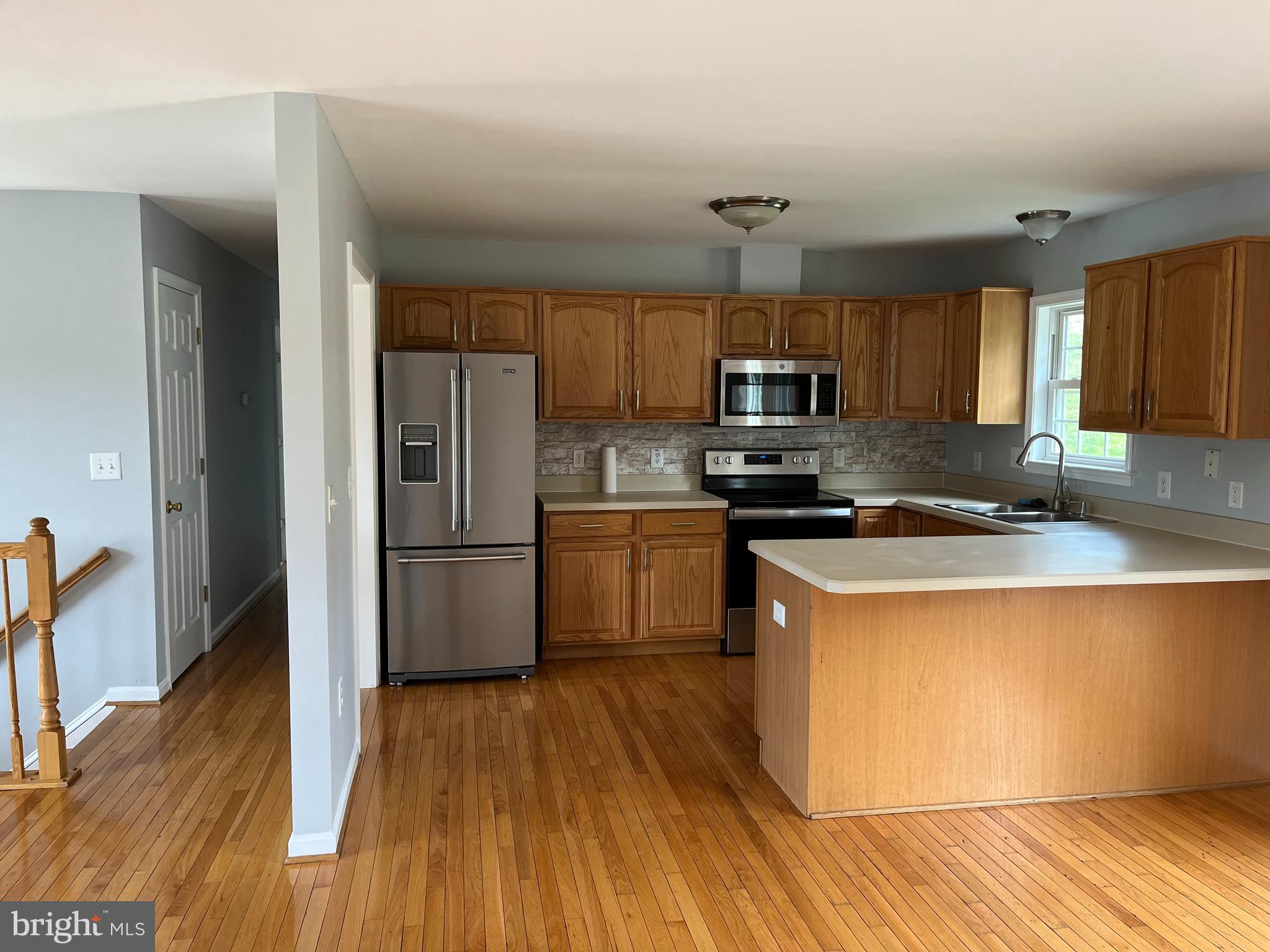 994 View Crest Court Front Royal, VA 22630 - Photo 8 of 24 a kitchen with granite countertop a refrigerator stove top oven and sink