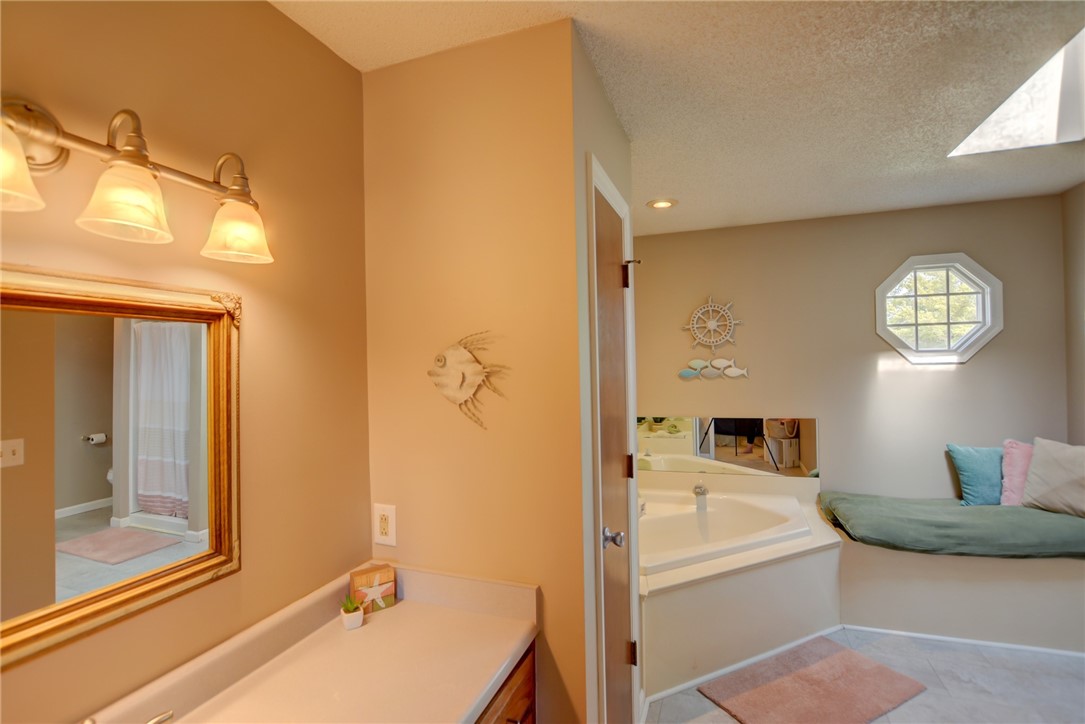 4095 West Rock Springs Road Decatur, IL 62522 - Photo 14 of 48 a spacious bathroom with a tub shower and mirror