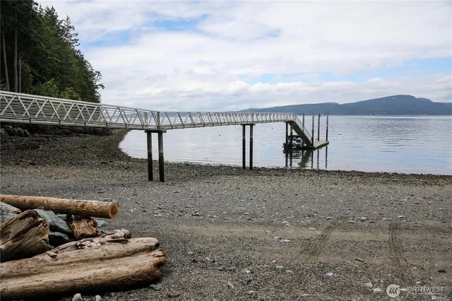 a view of a lake with a table and chairs