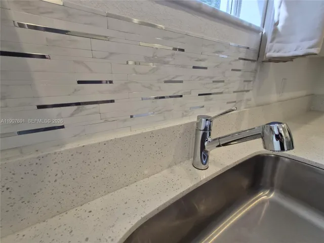 a kitchen with stainless steel appliances a refrigerator sink and microwave