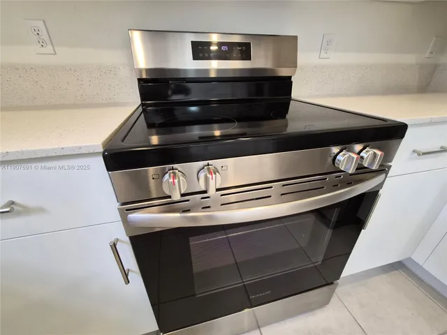 a kitchen with stainless steel appliances a refrigerator sink and microwave