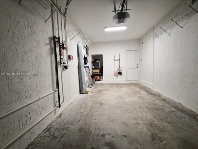 a view of kitchen with granite countertop cabinets and sink