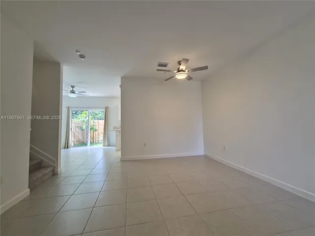 an empty room with closet and windows
