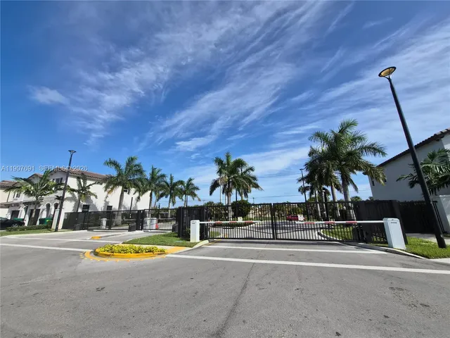 a view of swimming pool with outdoor seating and house in the background