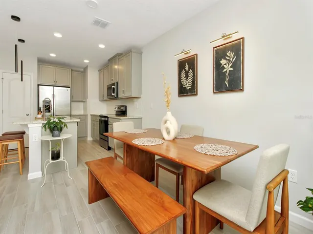 a dining room with furniture and wooden floor