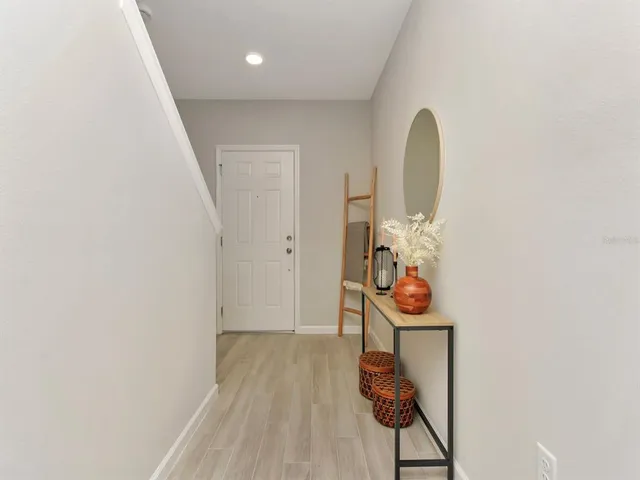 an entryway with wooden floor