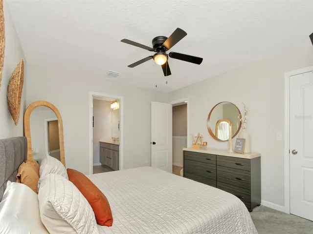 a bedroom with a bed and cabinets