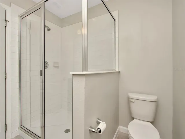 a bathroom with a toilet and a shower