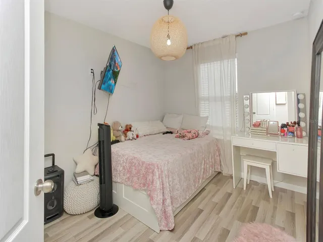 a bedroom with a bed and a chandelier