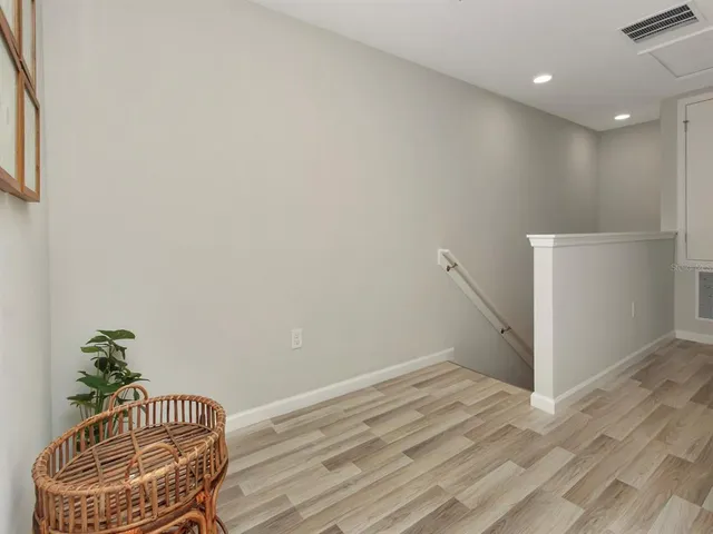 a view of room with wooden floor