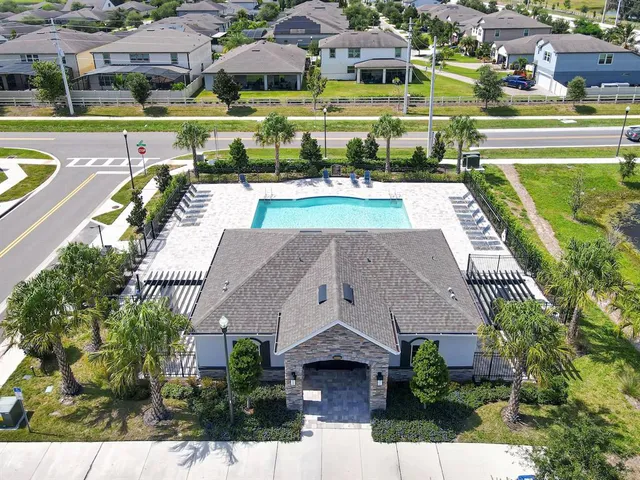 an aerial view of a house with garden space and street view