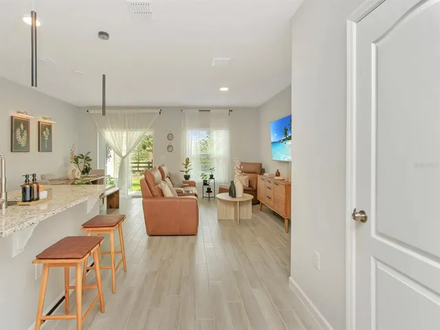 a living room with furniture and a wooden floor