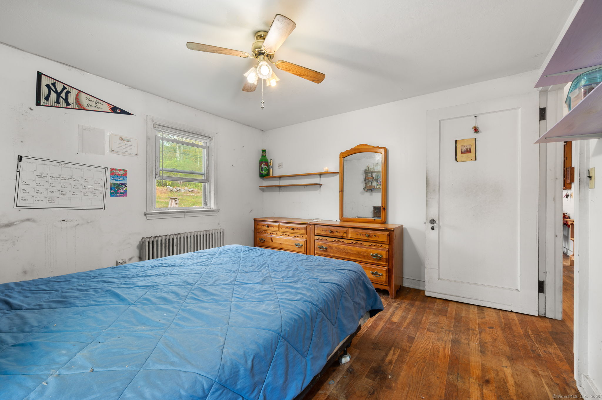 210 Butlertown Road Waterford, CT 06385 - Photo 14 of 25 a bedroom with a bed and a chandelier