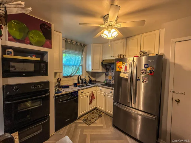 a kitchen with stainless steel appliances a stove refrigerator and microwave