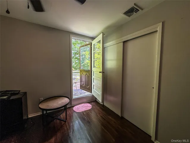 a view of a room with furniture and wooden floor