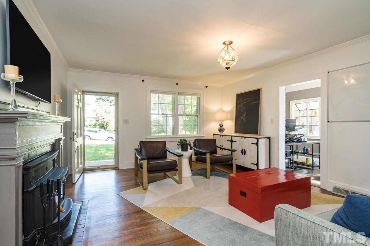 1621 Lorraine Road Raleigh, NC 27607 - Photo 13 of 28 a living room with furniture fireplace and flat screen tv