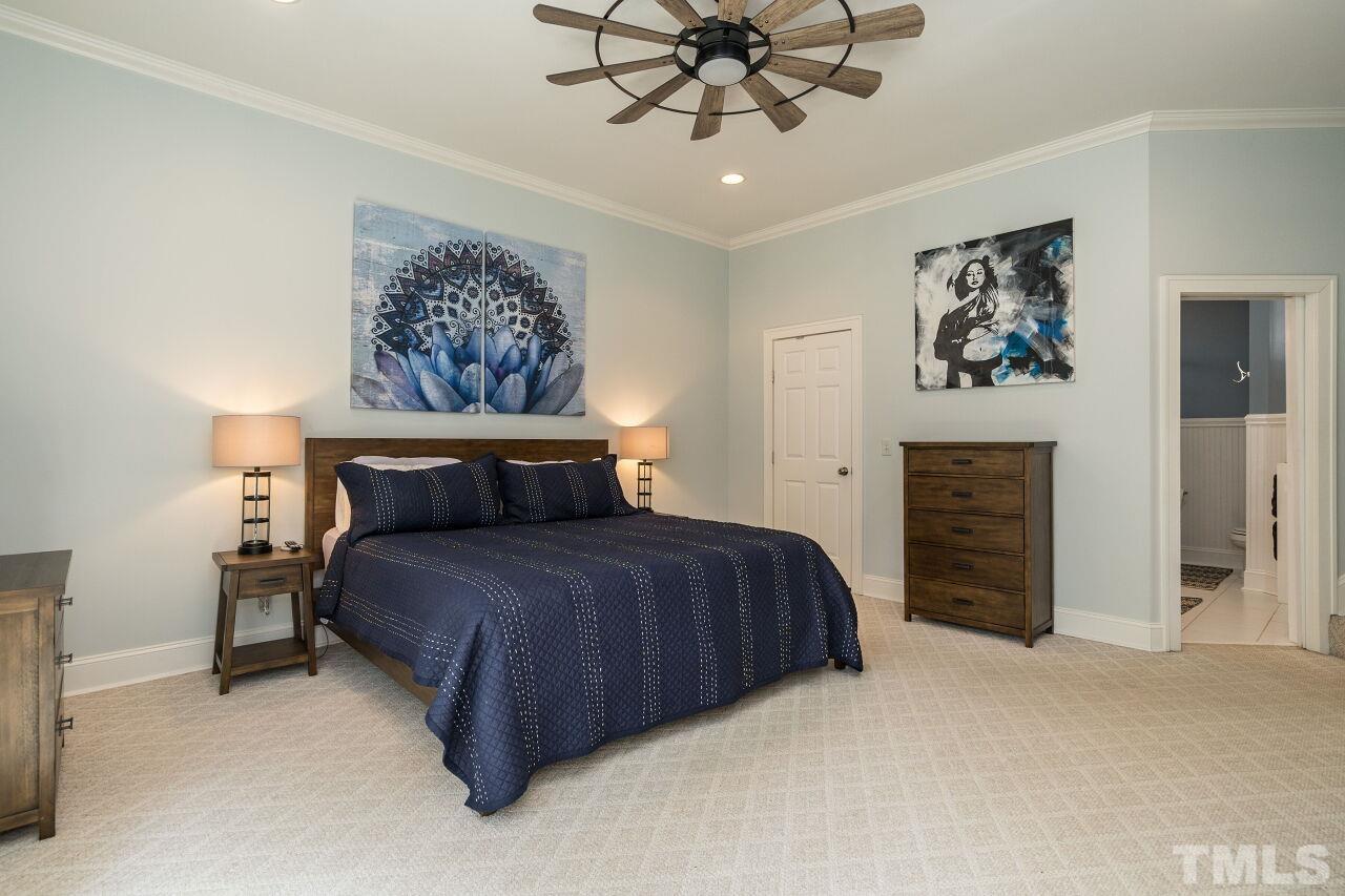 1621 Lorraine Road Raleigh, NC 27607 - Photo 19 of 28 a bedroom with a bed and a chandelier
