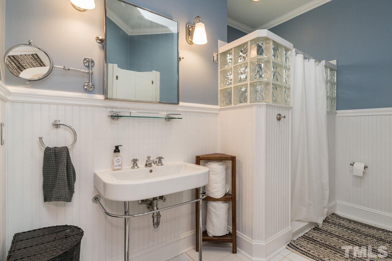1621 Lorraine Road Raleigh, NC 27607 - Photo 20 of 28 a bathroom with a sink and a mirror
