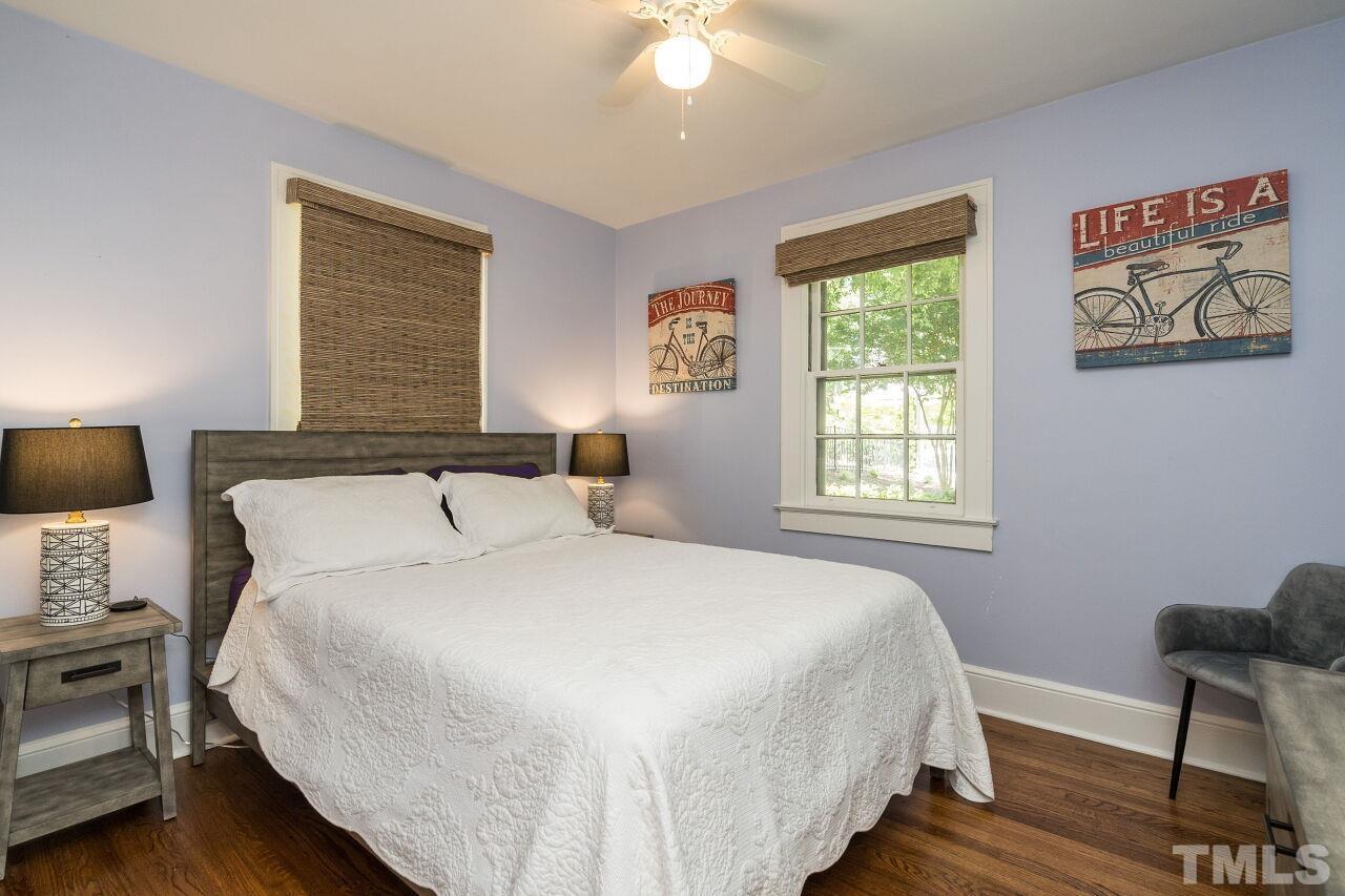1621 Lorraine Road Raleigh, NC 27607 - Photo 21 of 28 a bedroom with a bed and wooden floor