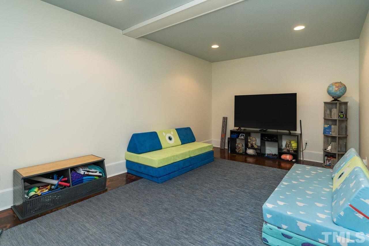 1621 Lorraine Road Raleigh, NC 27607 - Photo 24 of 28 a living room with furniture and a flat screen tv