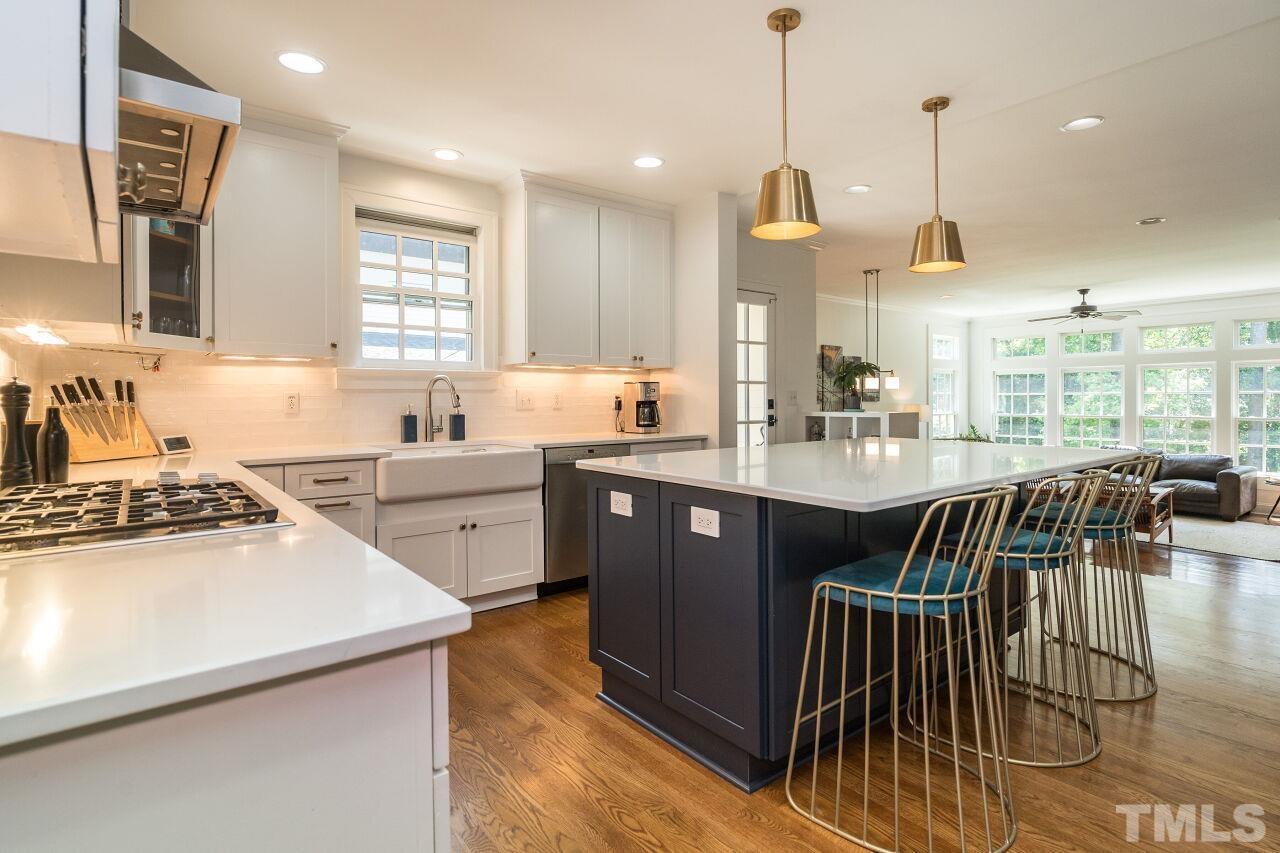 1621 Lorraine Road Raleigh, NC 27607 - Photo 3 of 28 a kitchen with sink a stove and chairs