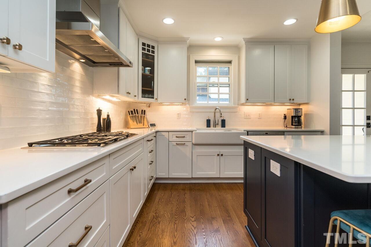 1621 Lorraine Road Raleigh, NC 27607 - Photo 4 of 28 a kitchen with sink stove and cabinets