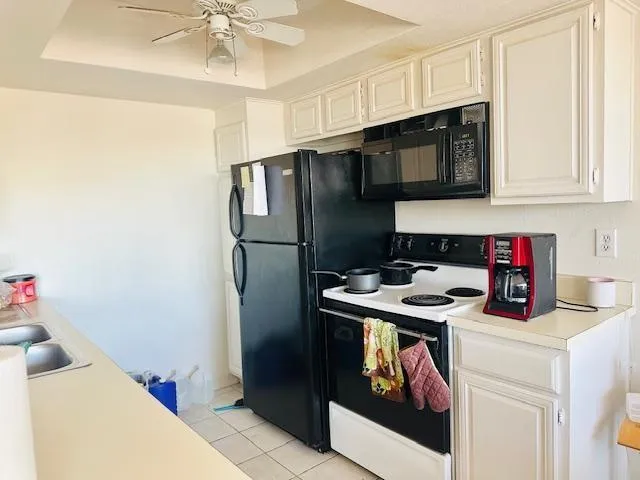 a kitchen with stainless steel appliances granite countertop a refrigerator and a stove