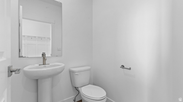 4170 North 560th West, Unit 6 Tooele, UT 84074 - Photo 8 of 20 Pedestal sink with a contemporary brushed nickel faucet and a rectangular mirror