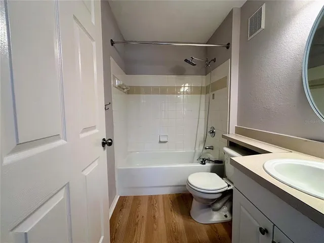 a bathroom with a granite countertop toilet sink and shower
