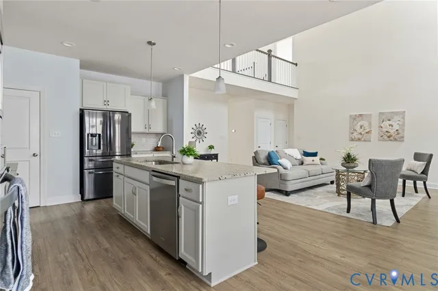 a kitchen with stainless steel appliances kitchen island granite countertop a stove and a refrigerator