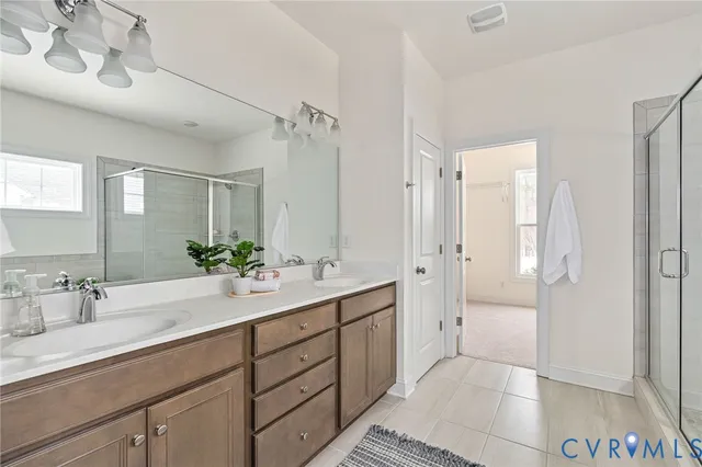 a bathroom with a tub mirror and sink